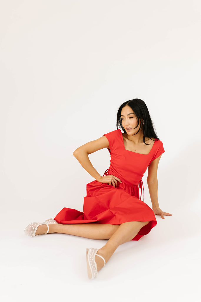 zoco afterglow dress: red short sleeve midi dress with a square neckline and side ties. perfect for date nights, weddings, and family pictures.