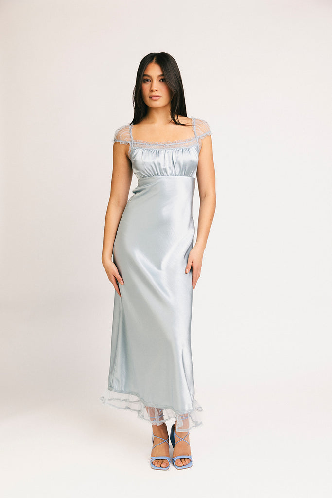 a light blue silk midi dress with lace detailing + a fitted silhouette. the perfect short sleeve occasion dress for weddings, bridal showers, + dinner parties.
