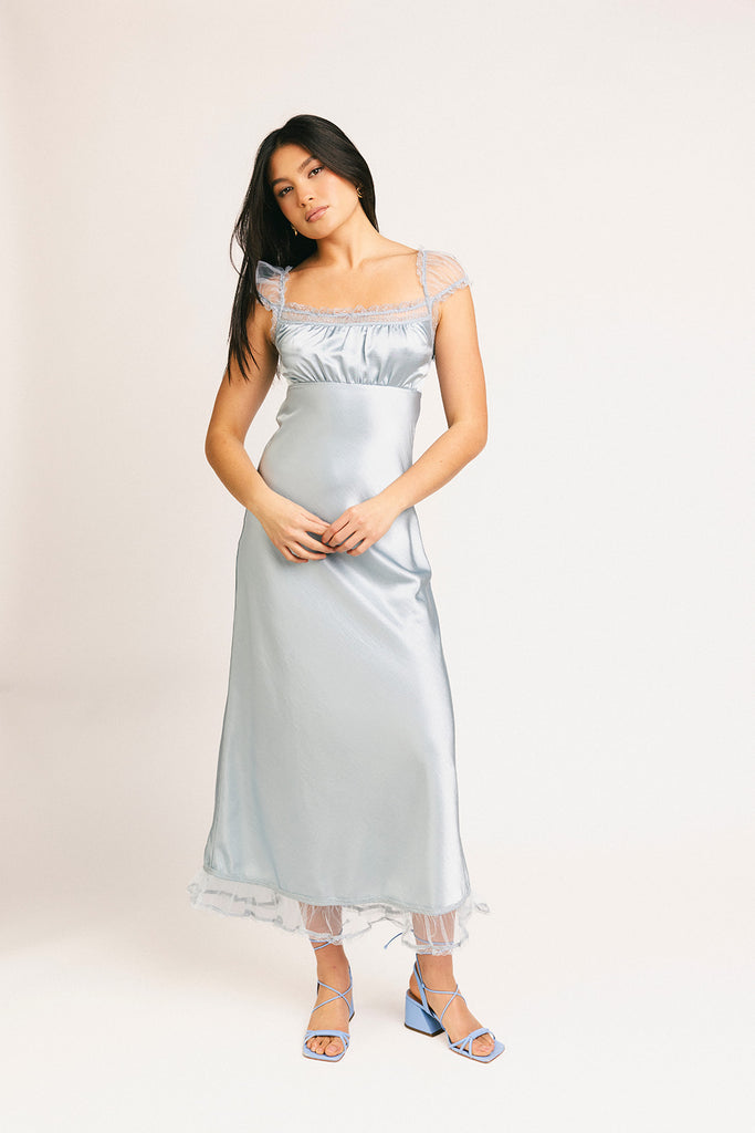 a light blue silk midi dress with lace detailing + a fitted silhouette. the perfect short sleeve occasion dress for weddings, bridal showers, + dinner parties.