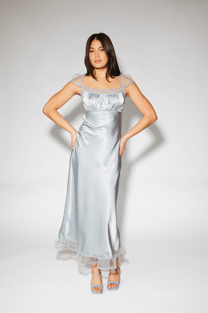 a light blue silk midi dress with lace detailing + a fitted silhouette. the perfect short sleeve occasion dress for weddings, bridal showers, + dinner parties.