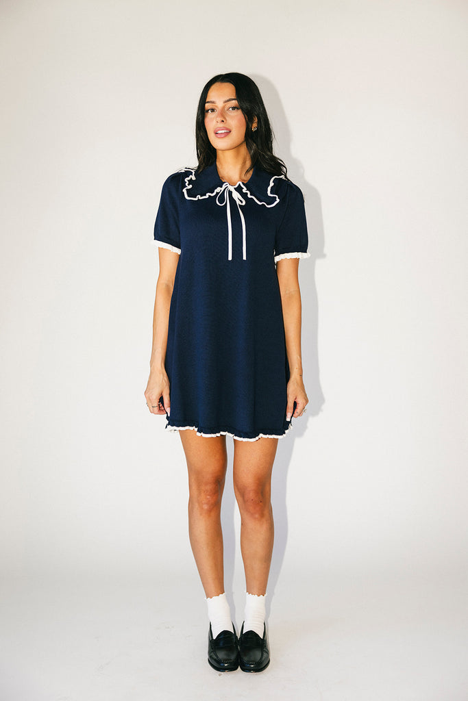 a short sleeve knit mini dress with a ruffled collar + bow detail. the perfect navy knit dress for date nights, family pictures, + everyday wear.
