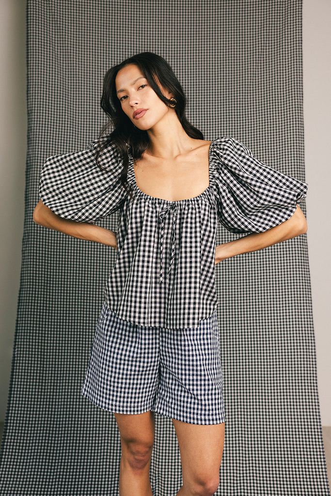 black and white gingham puff sleeve top with an elastic neckline + bow detail. the perfect elevated basic top for date nights + casual outfits.