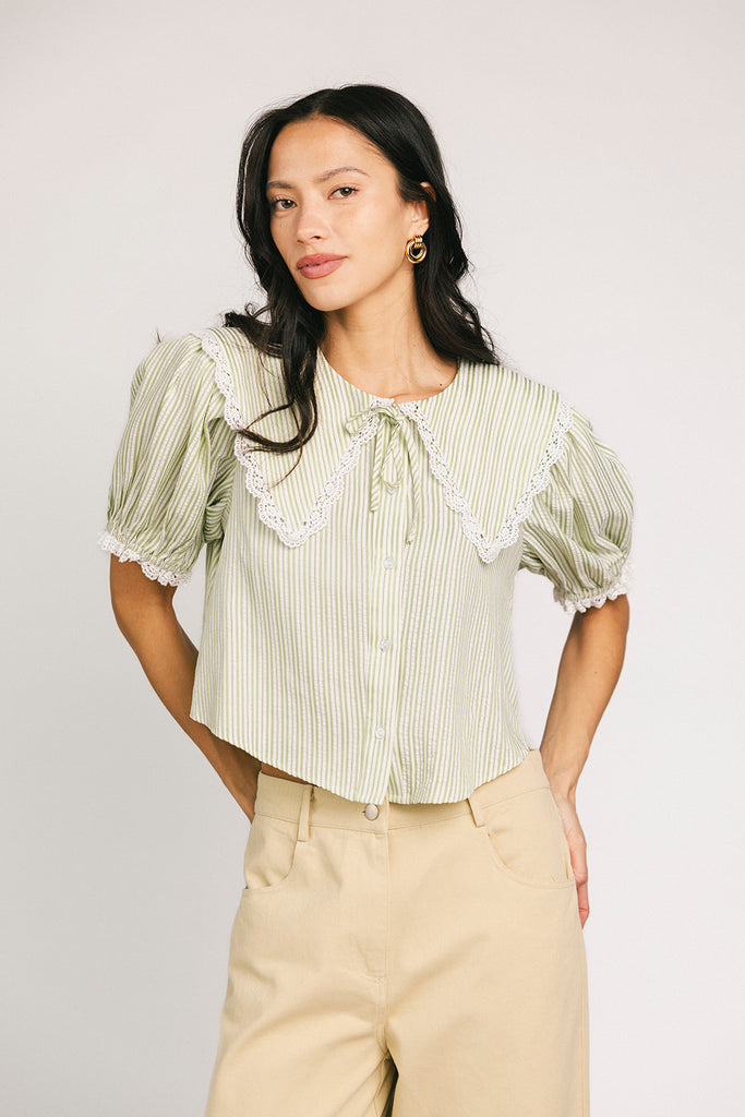 a vintage-inspired puff sleeve top with a pastel green pinstripe pattern + an oversized lace trim collar. the perfect elevated button up top for the office, dressy date nights, + everyday wear.