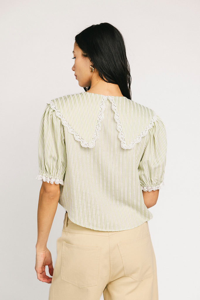 a vintage-inspired puff sleeve top with a pastel green pinstripe pattern + an oversized lace trim collar. the perfect elevated button up top for the office, dressy date nights, + everyday wear.