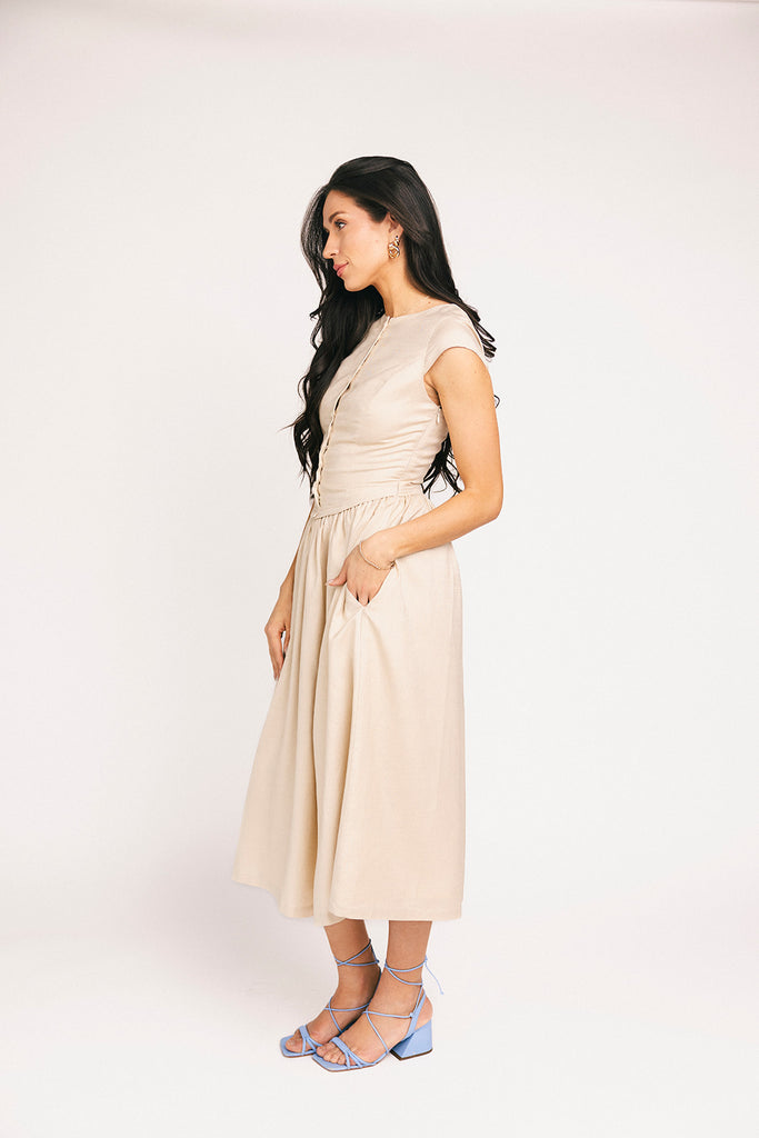 vintage-inspired dress with a fitted button-up bodice. the perfect neutral short sleeve dress for family pictures, bridal showers, + semi-formal events.