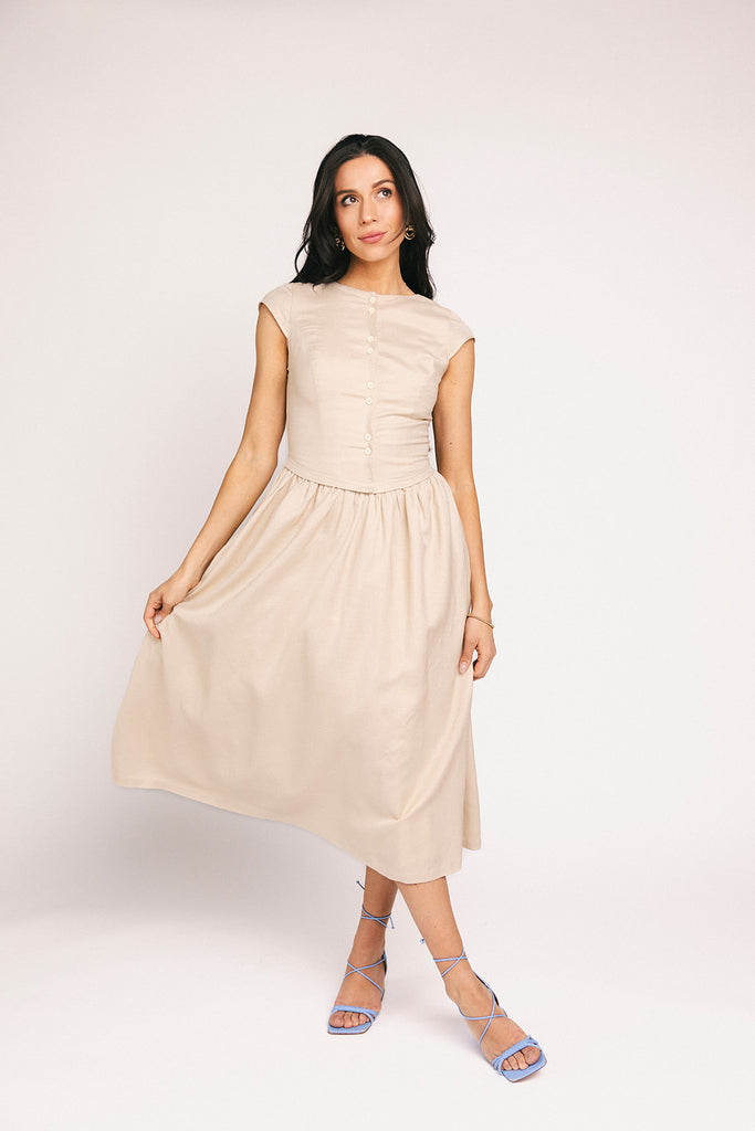 vintage-inspired dress with a fitted button-up bodice. the perfect neutral short sleeve dress for family pictures, bridal showers, + semi-formal events.