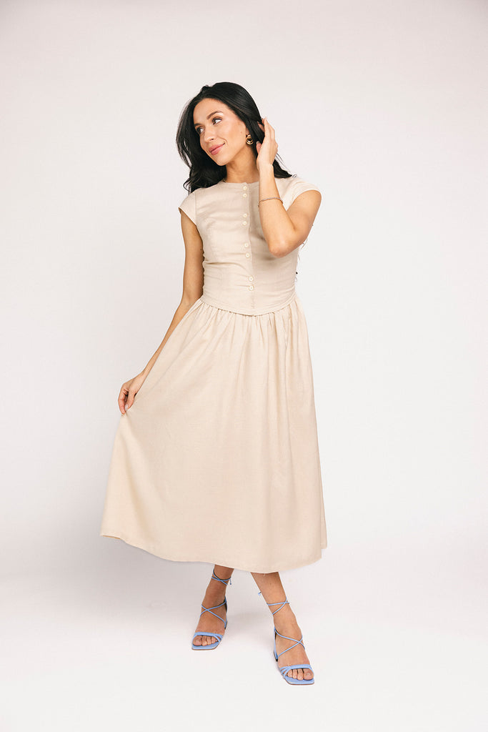 vintage-inspired dress with a fitted button-up bodice. the perfect neutral short sleeve dress for family pictures, bridal showers, + semi-formal events.
