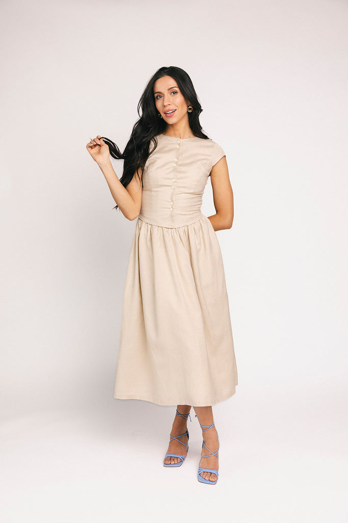 vintage-inspired dress with a fitted button-up bodice. the perfect neutral short sleeve dress for family pictures, bridal showers, + semi-formal events.
