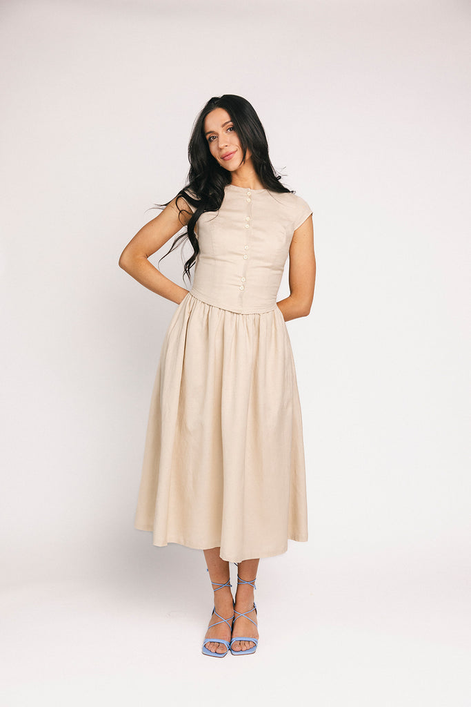vintage-inspired dress with a fitted button-up bodice. the perfect neutral short sleeve dress for family pictures, bridal showers, + semi-formal events.