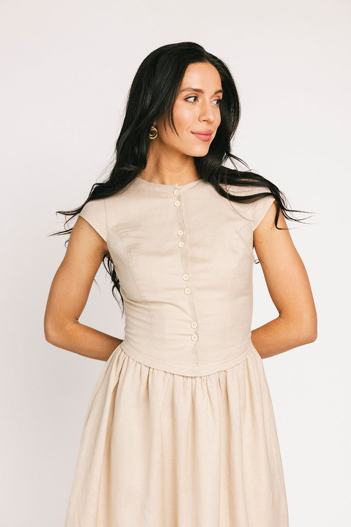 vintage-inspired dress with a fitted button-up bodice. the perfect neutral short sleeve dress for family pictures, bridal showers, + semi-formal events.