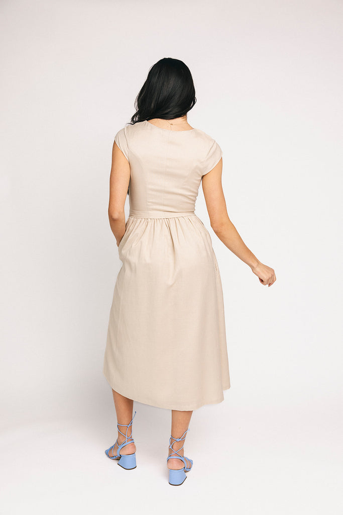 vintage-inspired dress with a fitted button-up bodice. the perfect neutral short sleeve dress for family pictures, bridal showers, + semi-formal events.