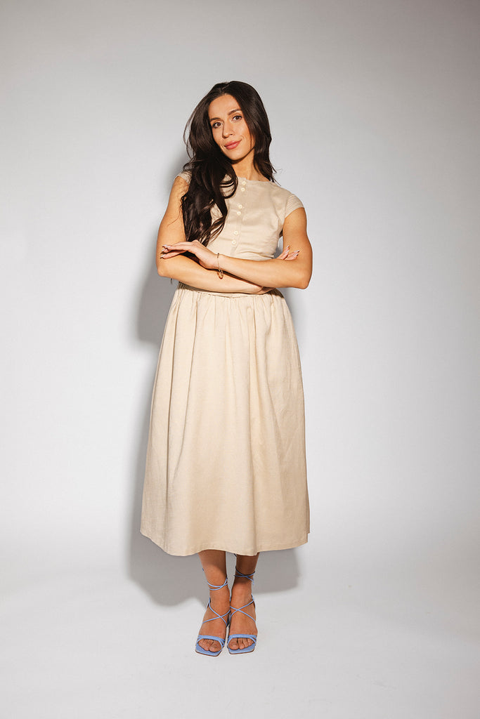 vintage-inspired dress with a fitted button-up bodice. the perfect neutral short sleeve dress for family pictures, bridal showers, + semi-formal events.