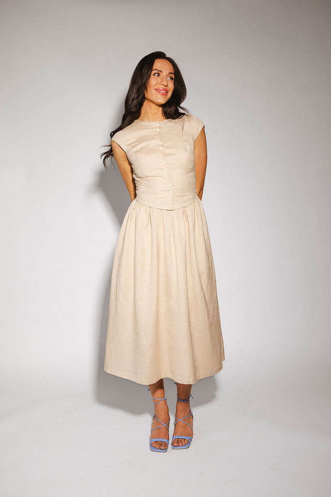 vintage-inspired dress with a fitted button-up bodice. the perfect neutral short sleeve dress for family pictures, bridal showers, + semi-formal events.