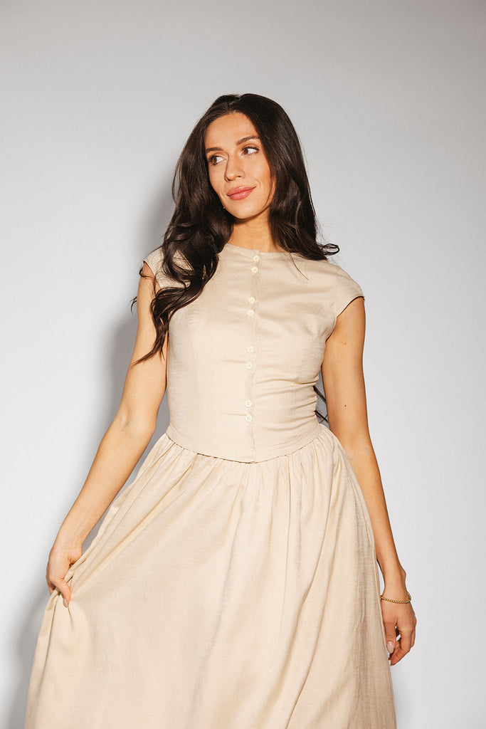 vintage-inspired dress with a fitted button-up bodice. the perfect neutral short sleeve dress for family pictures, bridal showers, + semi-formal events.
