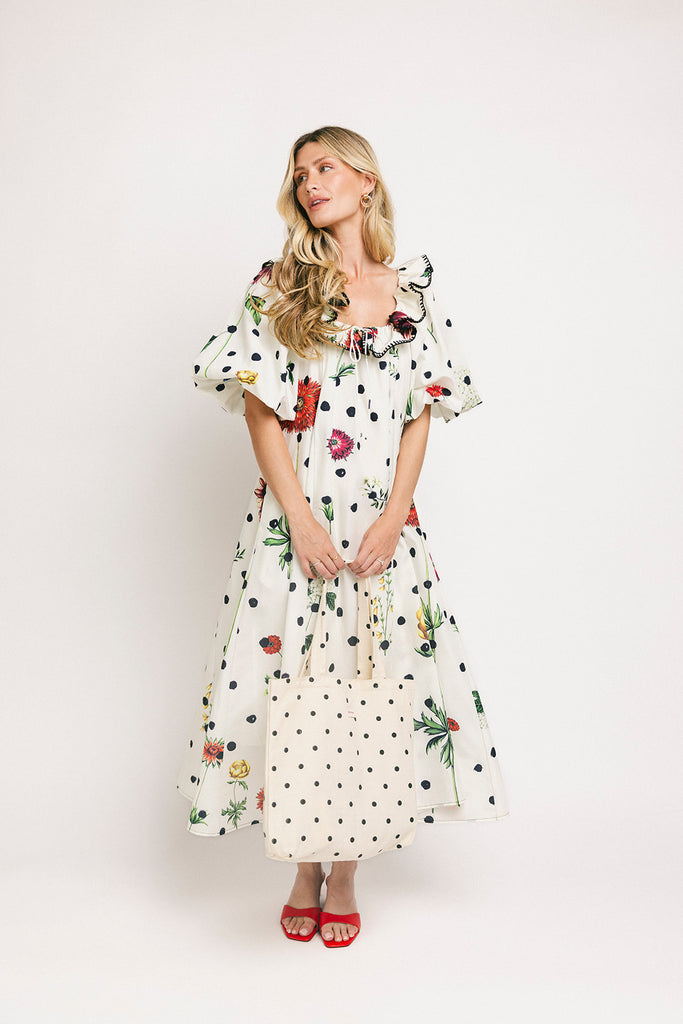 a polka dot puff sleeve dress with floral print details. the perfect polka dot midi dress for baby showers, family pictures, + special occasions.