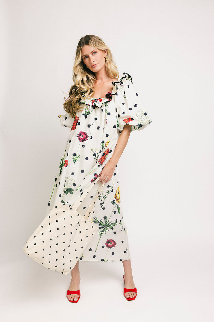 a polka dot puff sleeve dress with floral print details. the perfect polka dot midi dress for baby showers, family pictures, + special occasions.