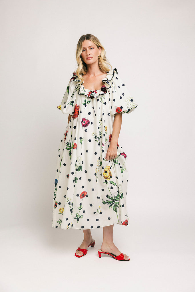 a polka dot puff sleeve dress with floral print details. the perfect polka dot midi dress for baby showers, family pictures, + special occasions.