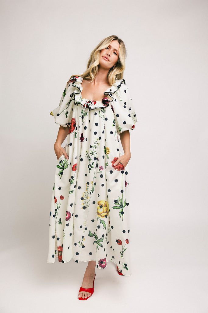 a polka dot puff sleeve dress with floral print details. the perfect polka dot midi dress for baby showers, family pictures, + special occasions.