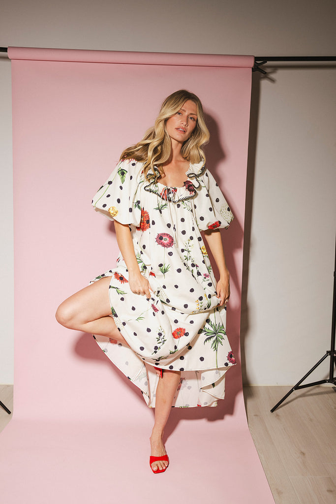 a polka dot puff sleeve dress with floral print details. the perfect polka dot midi dress for baby showers, family pictures, + special occasions.