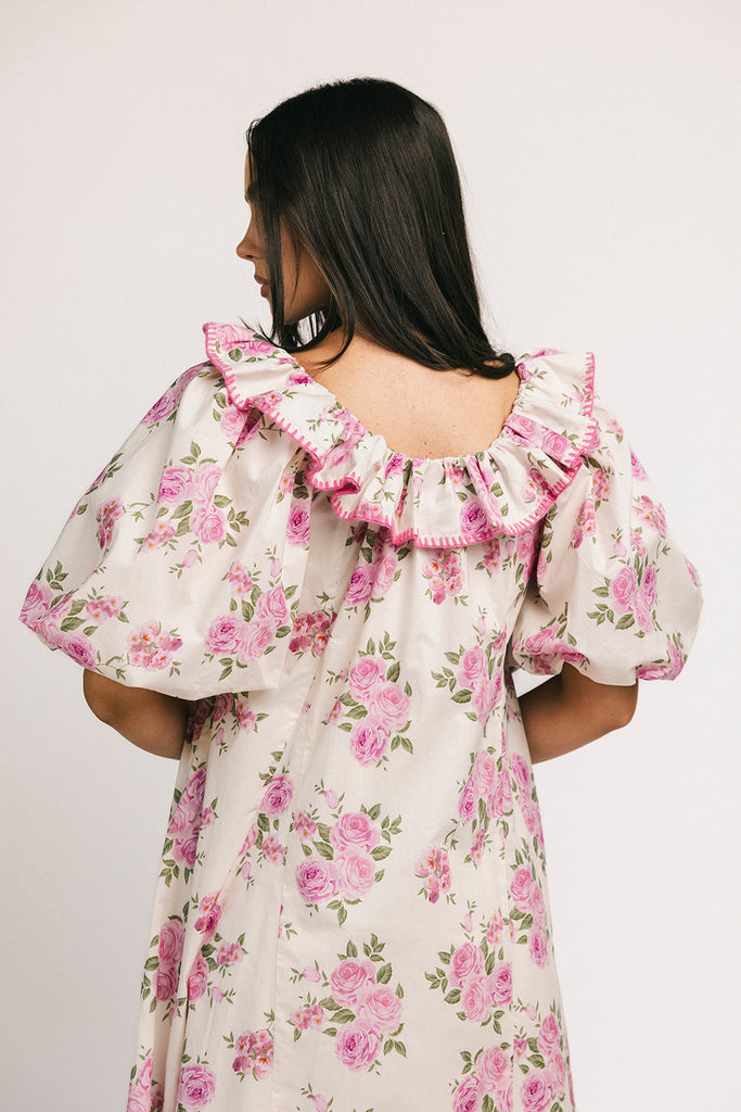 a pink floral puff sleeve dress with a ruffle neckline. the perfect vintage-inspired dress for baby showers, family pictures, + special occasions.