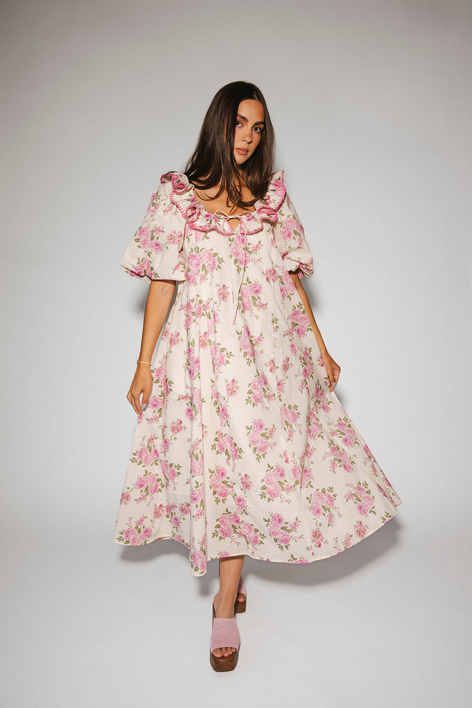 a pink floral puff sleeve dress with a ruffle neckline. the perfect vintage-inspired dress for baby showers, family pictures, + special occasions.