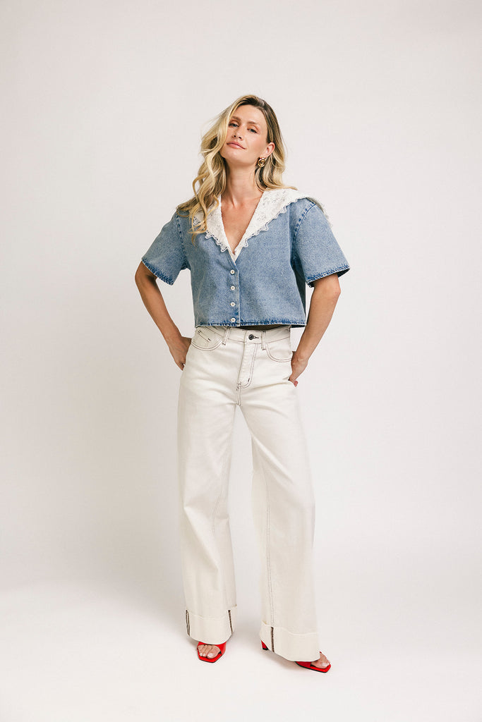 a short sleeve denim top with an oversized lace collar + a cropped silhouette. the perfect button up denim top to dress up or down for any outfit idea.