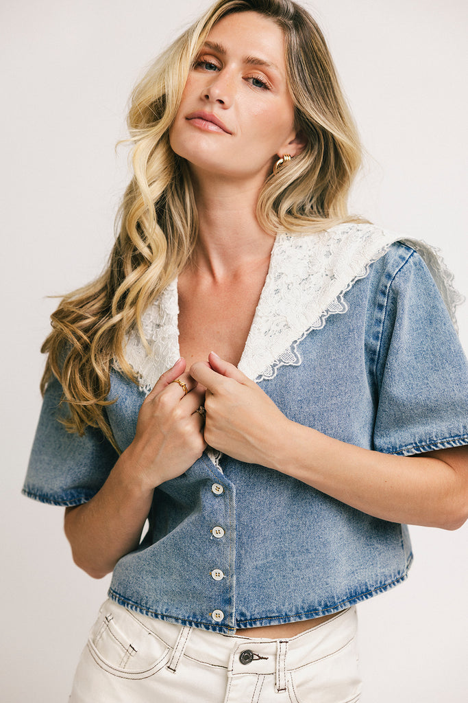 a short sleeve denim top with an oversized lace collar + a cropped silhouette. the perfect button up denim top to dress up or down for any outfit idea.