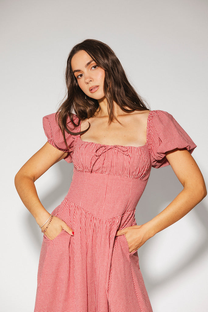 vintage-inspired puff sleeve dress with a square neckline. the perfect red gingham puff sleeve dress for rodeos, family pictures,+ semi-casual occasions.
