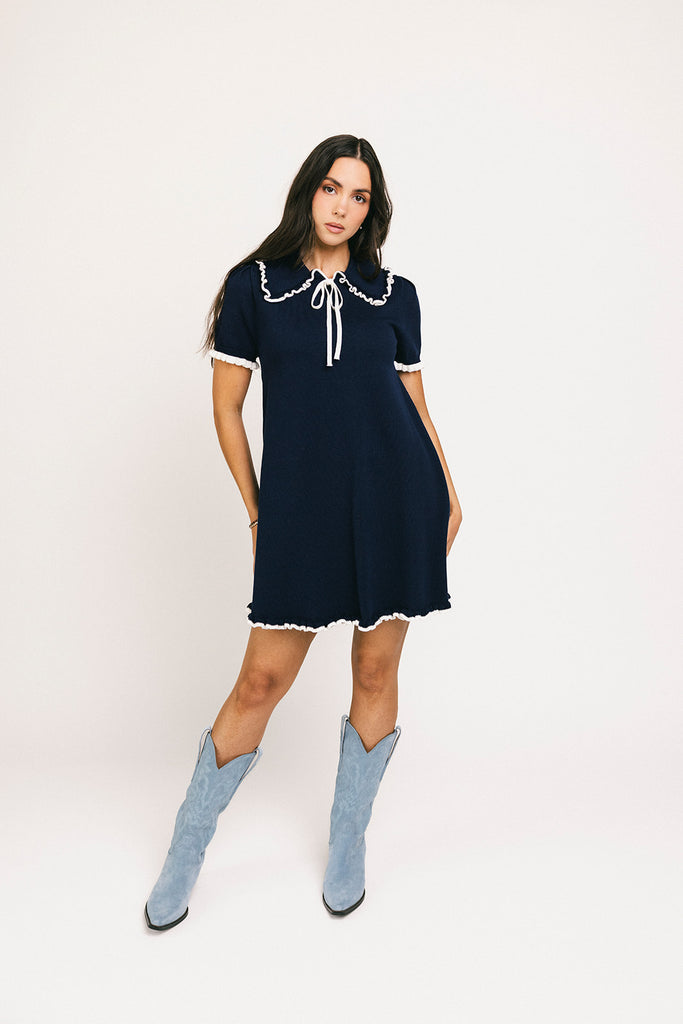 a short sleeve knit mini dress with a ruffled collar + bow detail. the perfect navy knit dress for date nights, family pictures, + everyday wear.