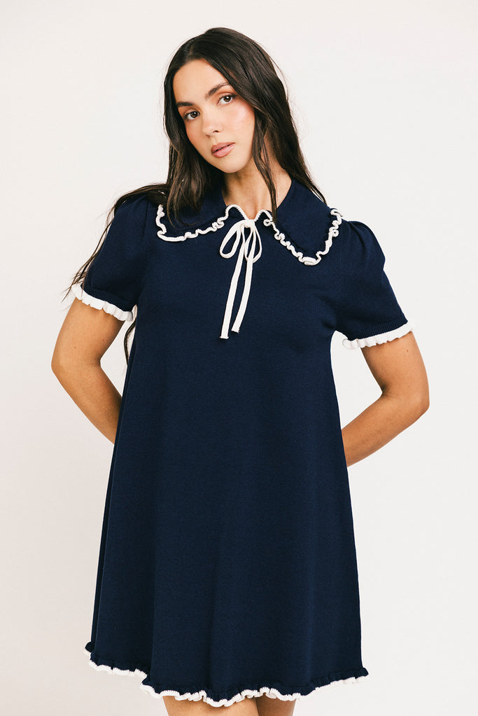 a short sleeve knit mini dress with a ruffled collar + bow detail. the perfect navy knit dress for date nights, family pictures, + everyday wear.