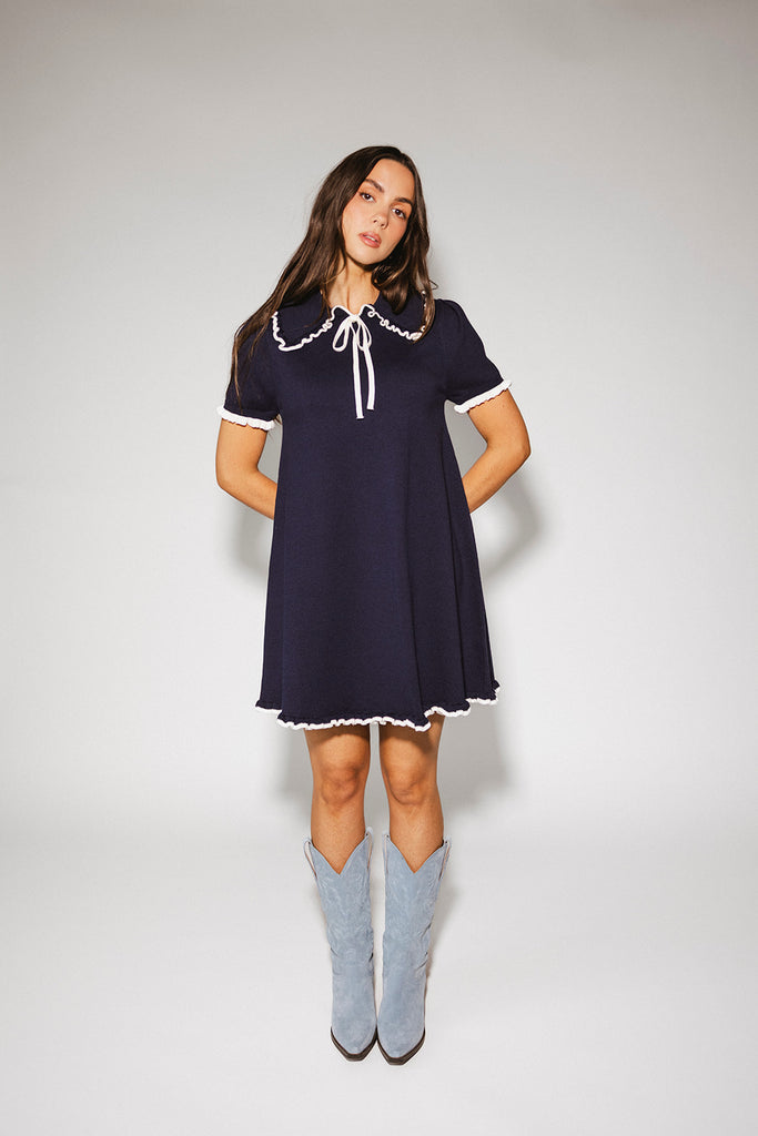a short sleeve knit mini dress with a ruffled collar + bow detail. the perfect navy knit dress for date nights, family pictures, + everyday wear.