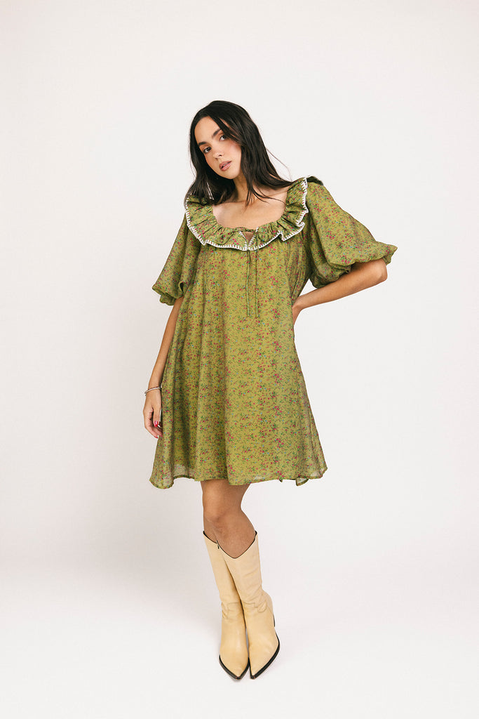 a green floral puff sleeve mini dress with a ruffle neckline. the perfect vintage-inspired dress for baby showers, family pictures, + special occasions.