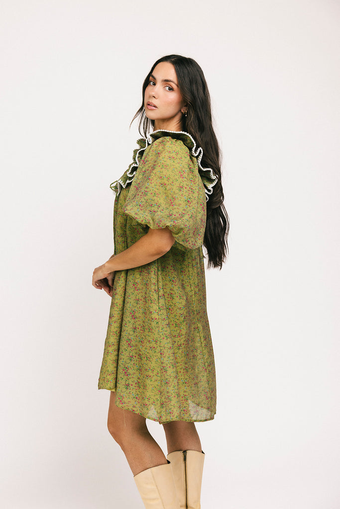 a green floral puff sleeve mini dress with a ruffle neckline. the perfect vintage-inspired dress for baby showers, family pictures, + special occasions.