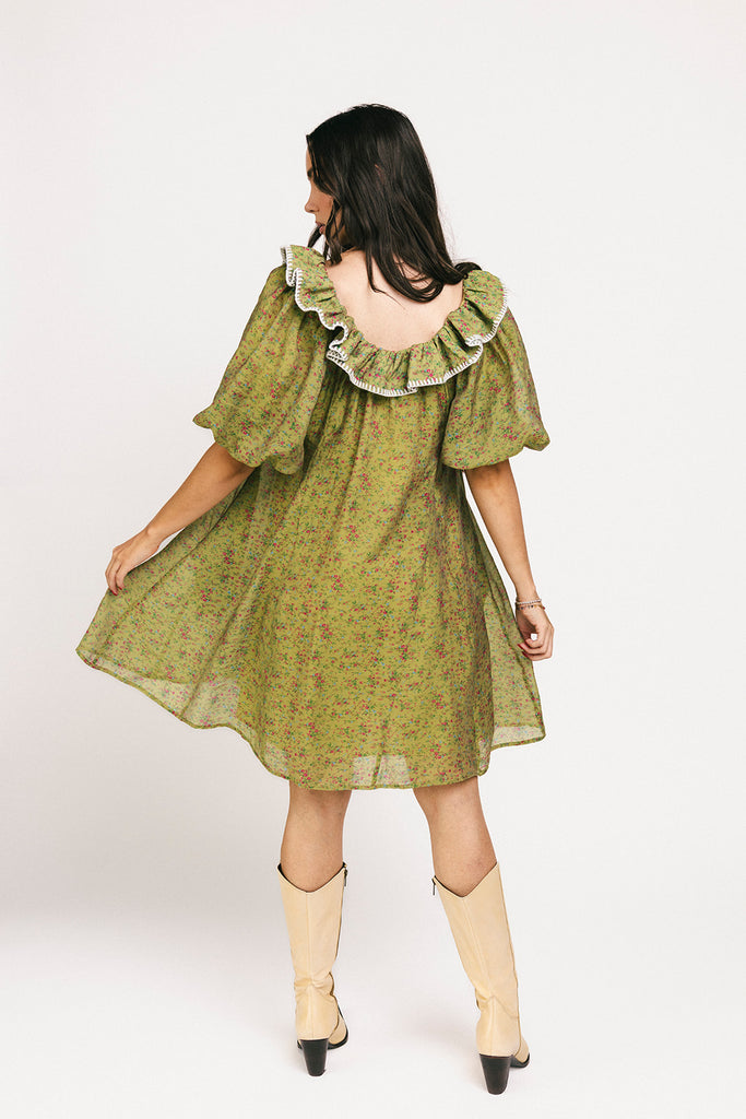 a green floral puff sleeve mini dress with a ruffle neckline. the perfect vintage-inspired dress for baby showers, family pictures, + special occasions.