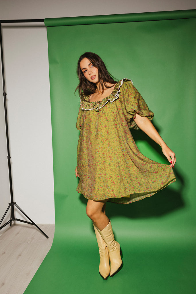 a green floral puff sleeve mini dress with a ruffle neckline. the perfect vintage-inspired dress for baby showers, family pictures, + special occasions.