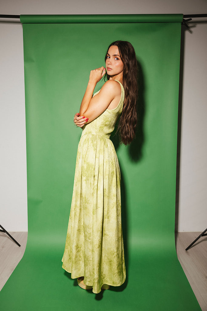a flowy v-waist green dress with a sleek scoop neckline + subtle floral print. the perfect vintage-inspired maxi dress for weddings, bridal showers, + garden parties.