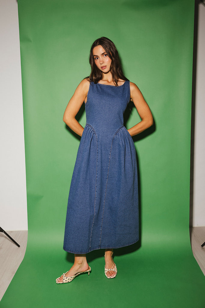 a vintage-inspired denim dress with a boat neckline + a v-shaped waistline. the perfect denim midi dress for family pictures, brunch dates, + special occasions.