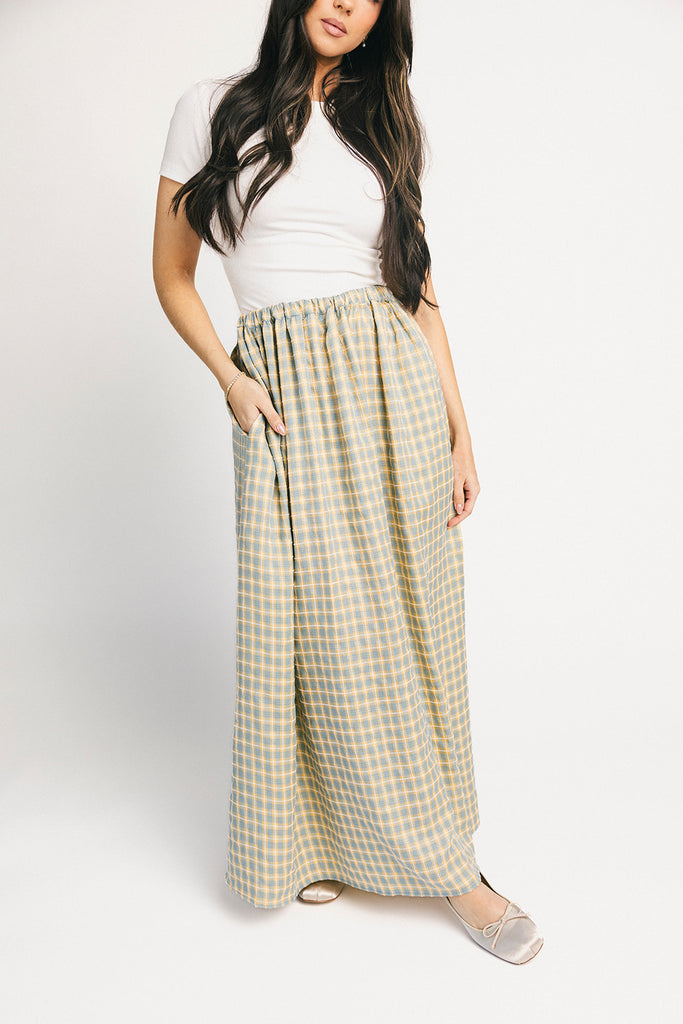 blue and yellow gingham maxi skirt with an elastic waist + side slit details. the perfect flowy gingham skirt to dress up or down for any outfit idea.
