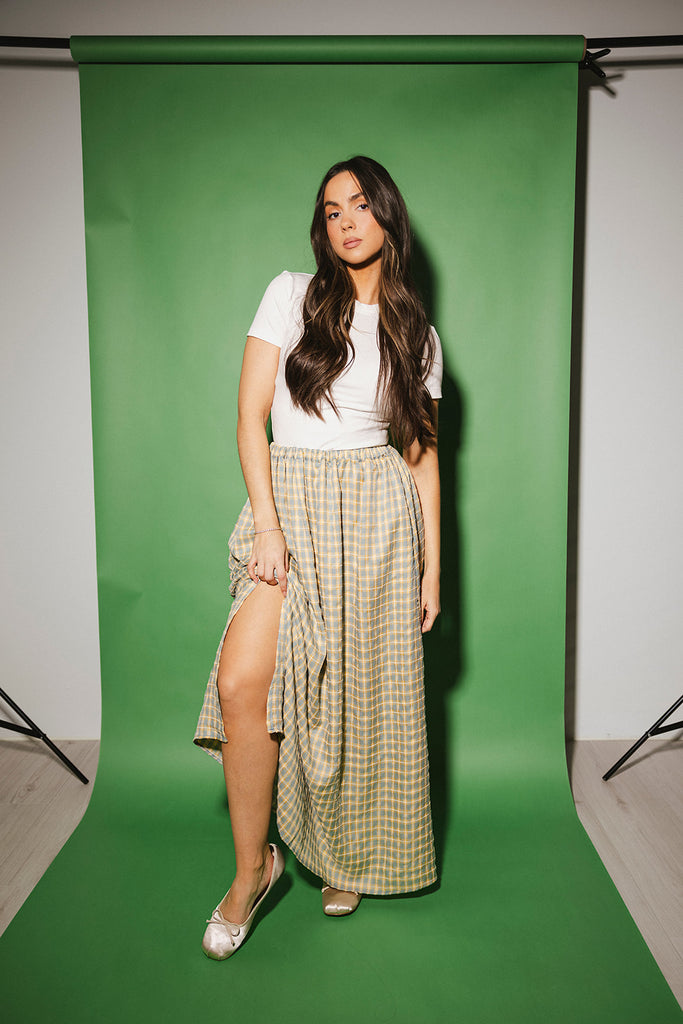 blue and yellow gingham maxi skirt with an elastic waist + side slit details. the perfect flowy gingham skirt to dress up or down for any outfit idea.