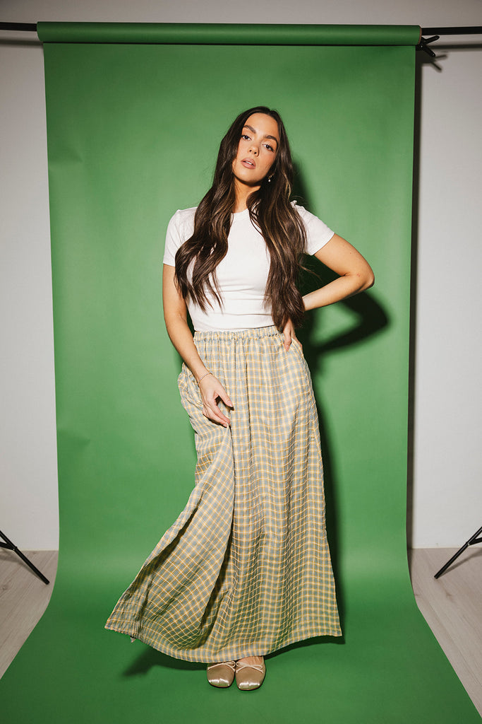 blue and yellow gingham maxi skirt with an elastic waist + side slit details. the perfect flowy gingham skirt to dress up or down for any outfit idea.