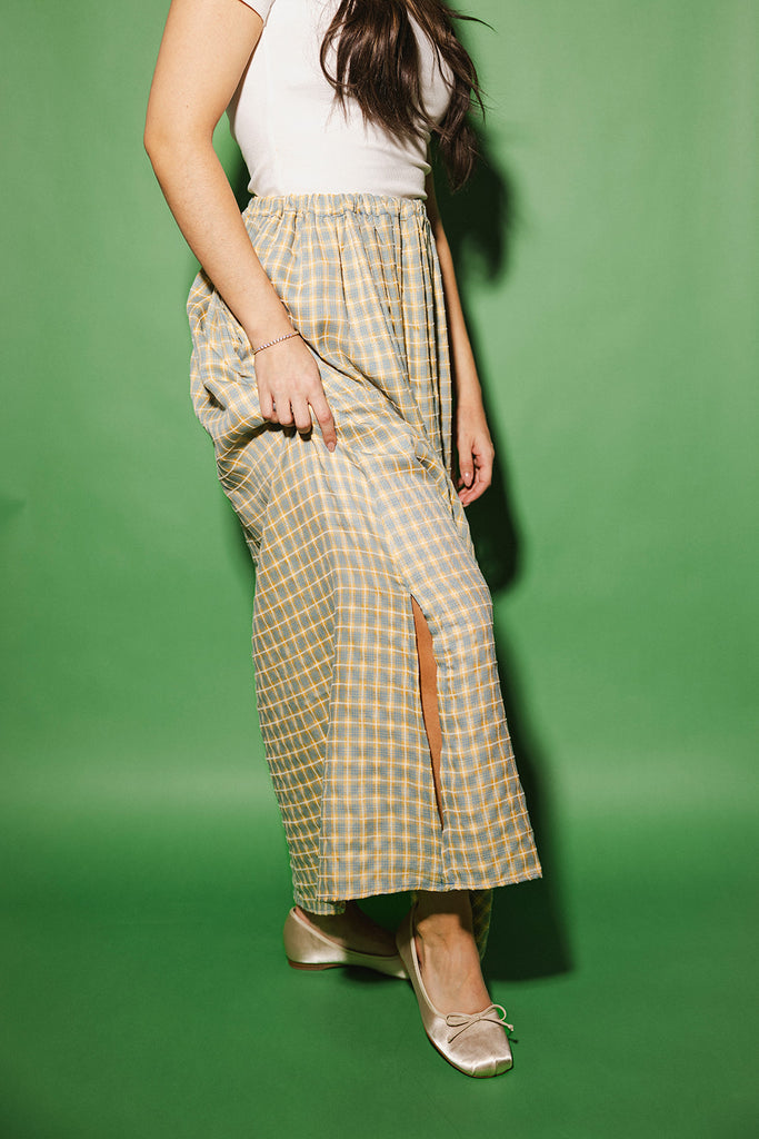 blue and yellow gingham maxi skirt with an elastic waist + side slit details. the perfect flowy gingham skirt to dress up or down for any outfit idea.