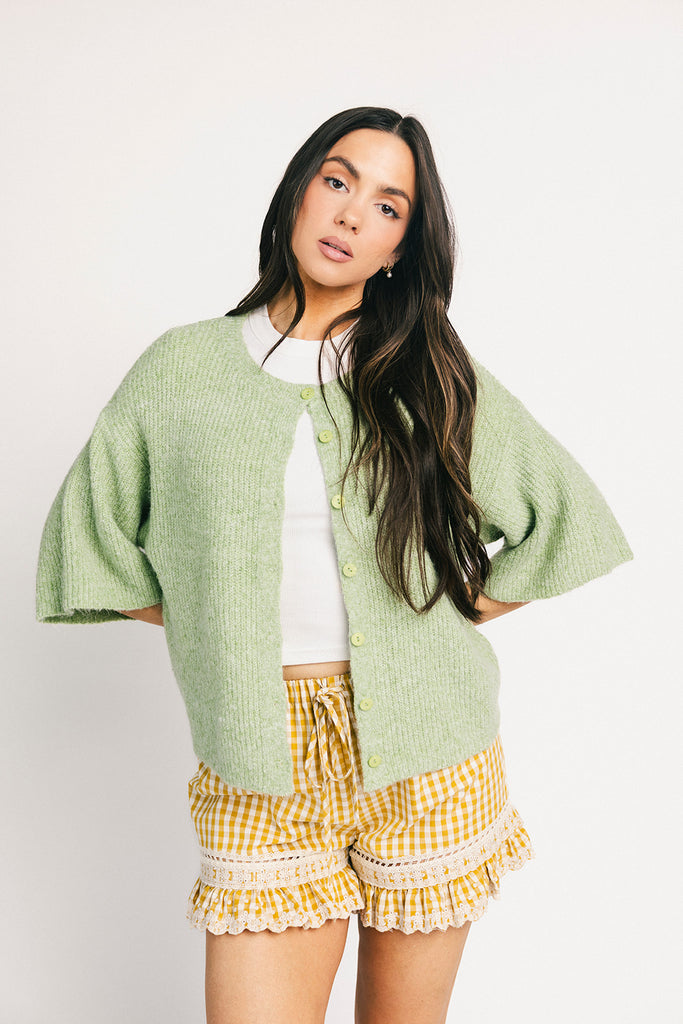 light green short sleeve cardigan with a slouchy, relaxed fit. perfect for casual outfits + lightweight layering.
