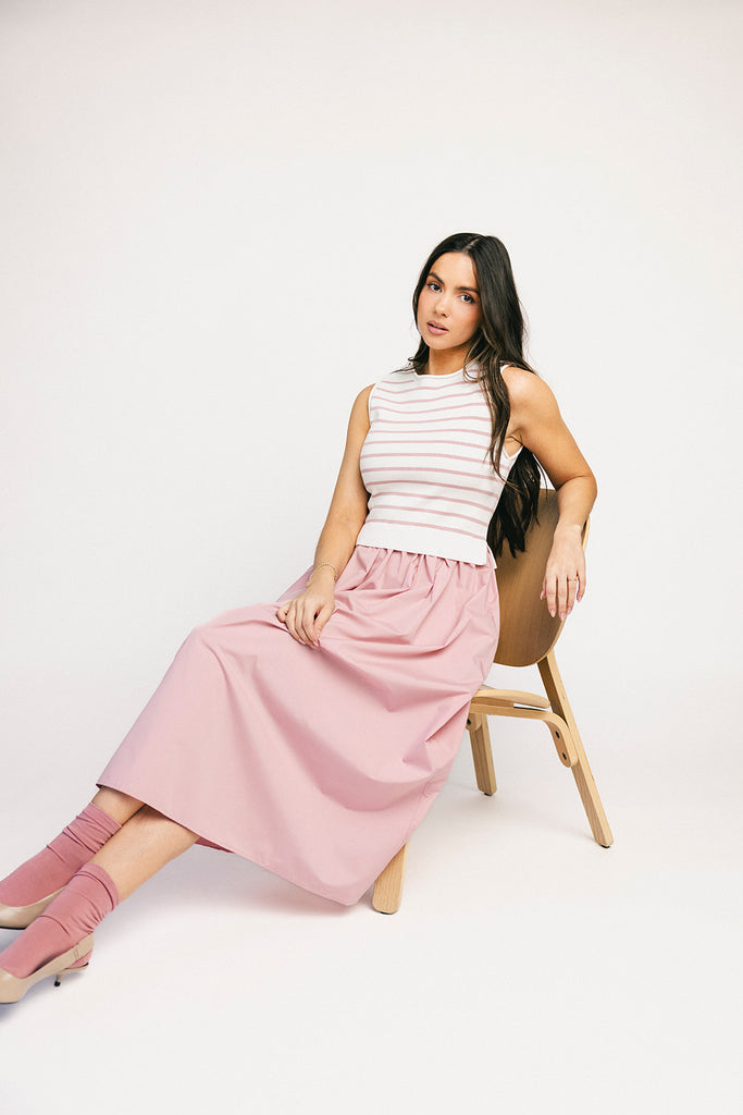 a-line pink midi dress with a striped knit vest detail. the perfect casual dress for baby showers, brunch dates, + family pictures.