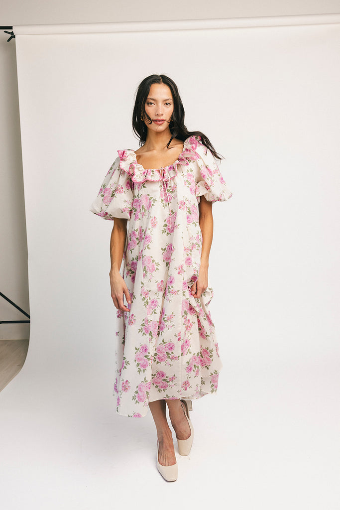 a pink floral puff sleeve dress with a ruffle neckline. the perfect vintage-inspired dress for baby showers, family pictures, + special occasions.