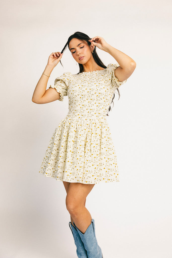 a floral puff sleeve dress with a smocked bodice + mini length. the perfect ditsy floral dress for family pictures, bridal showers, + brunch dates.