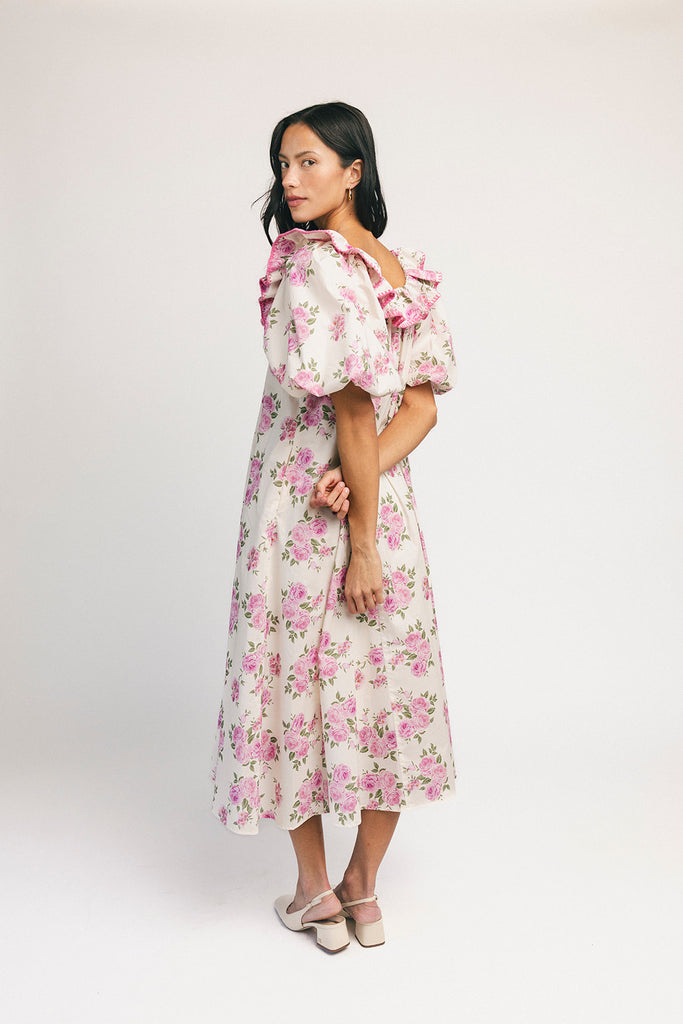 a pink floral puff sleeve dress with a ruffle neckline. the perfect vintage-inspired dress for baby showers, family pictures, + special occasions.
