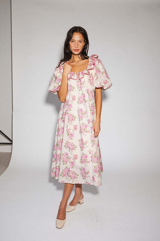 a pink floral puff sleeve dress with a ruffle neckline. the perfect vintage-inspired dress for baby showers, family pictures, + special occasions.