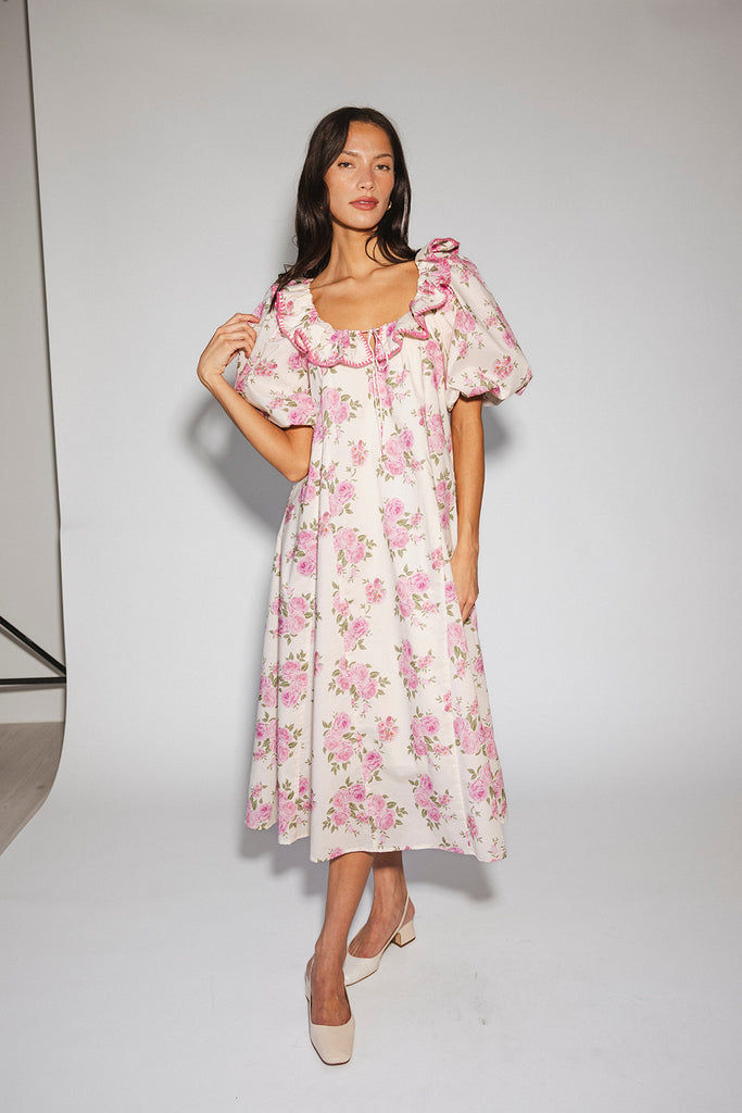 a pink floral puff sleeve dress with a ruffle neckline. the perfect vintage-inspired dress for baby showers, family pictures, + special occasions.