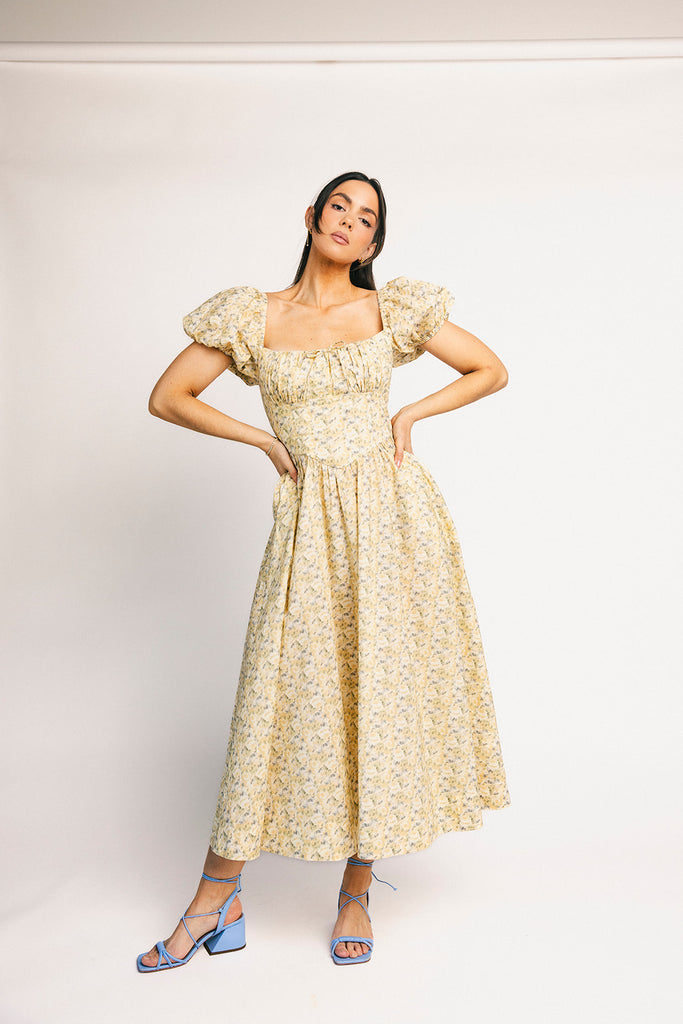vintage-inspired puff sleeve dress with a muted yellow floral pattern. the perfect puff sleeve midi dress for weddings, bridal showers, + semi-formal events.