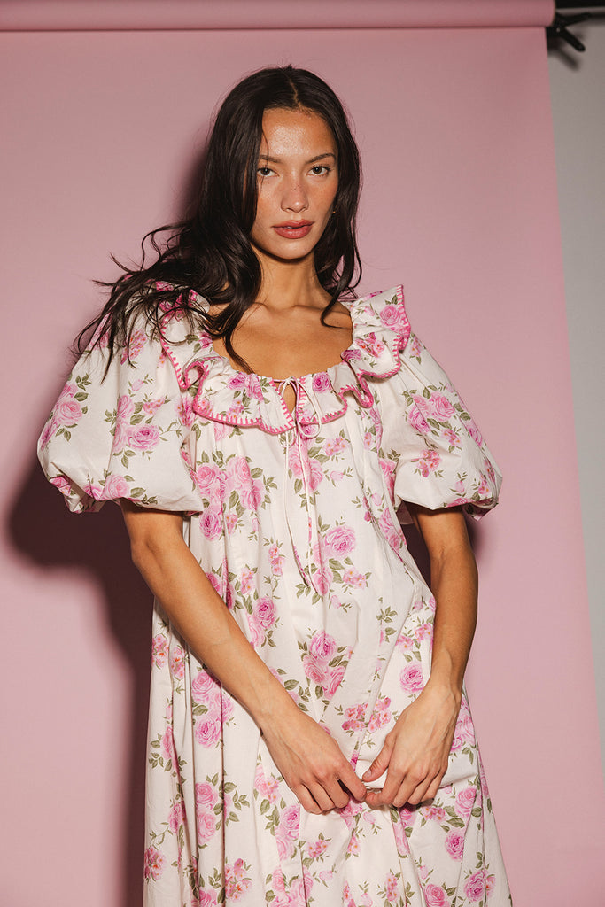 a pink floral puff sleeve dress with a ruffle neckline. the perfect vintage-inspired dress for baby showers, family pictures, + special occasions.